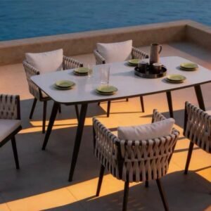 Elysian Dining – outdoor dining setting with light-top table and woven-back armchairs