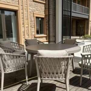 The Aira – round outdoor dining table with taupe diamond-lattice rope chairs